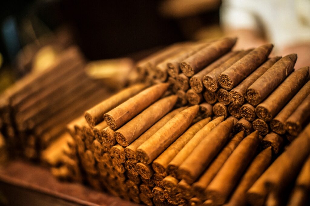 A pile of cigars on a table, with sizes explained.