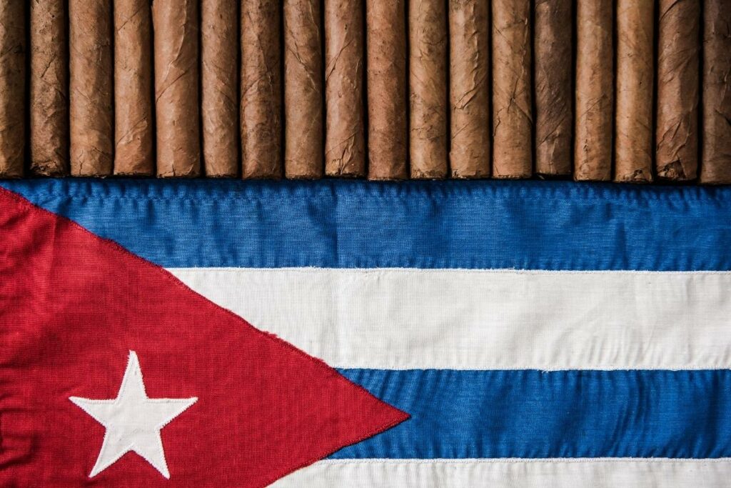 A background showcasing the Cuban flag and cigars.