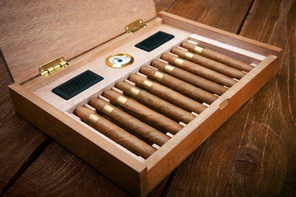 Cigar brands in a wooden box on a wooden table.