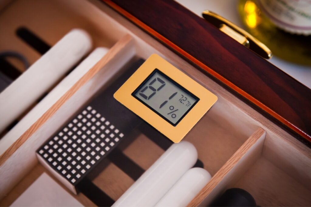 A wooden box with a digital timer and hygrometer in it.