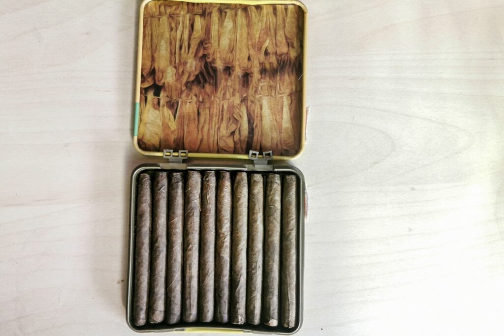 A travel-friendly tin of cigars in a wooden box.