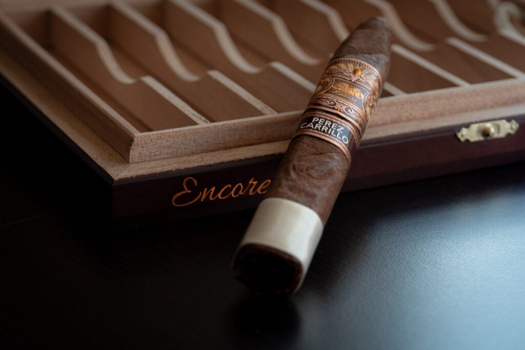 A travel-friendly cigar sitting in a wooden box on a table.