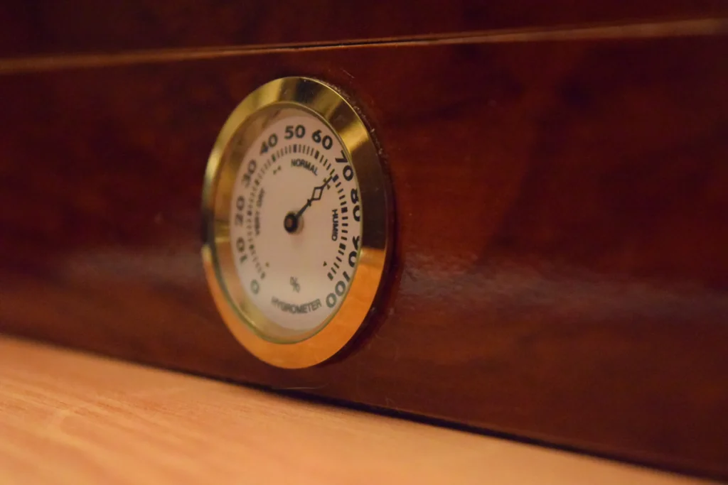 A hygrometer in a humidor for a meticulous humidor maintenance.