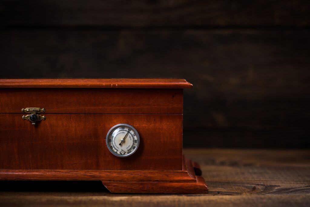 Choosing a humidor: A wooden box with a clock sitting on top.