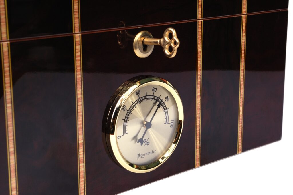 When selecting a humidor, consider this exquisite black and gold option adorned with a stylish clock.